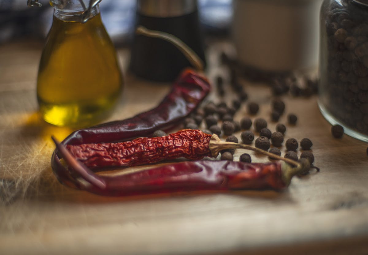 Dried red chilies beside a bottle of chili oil